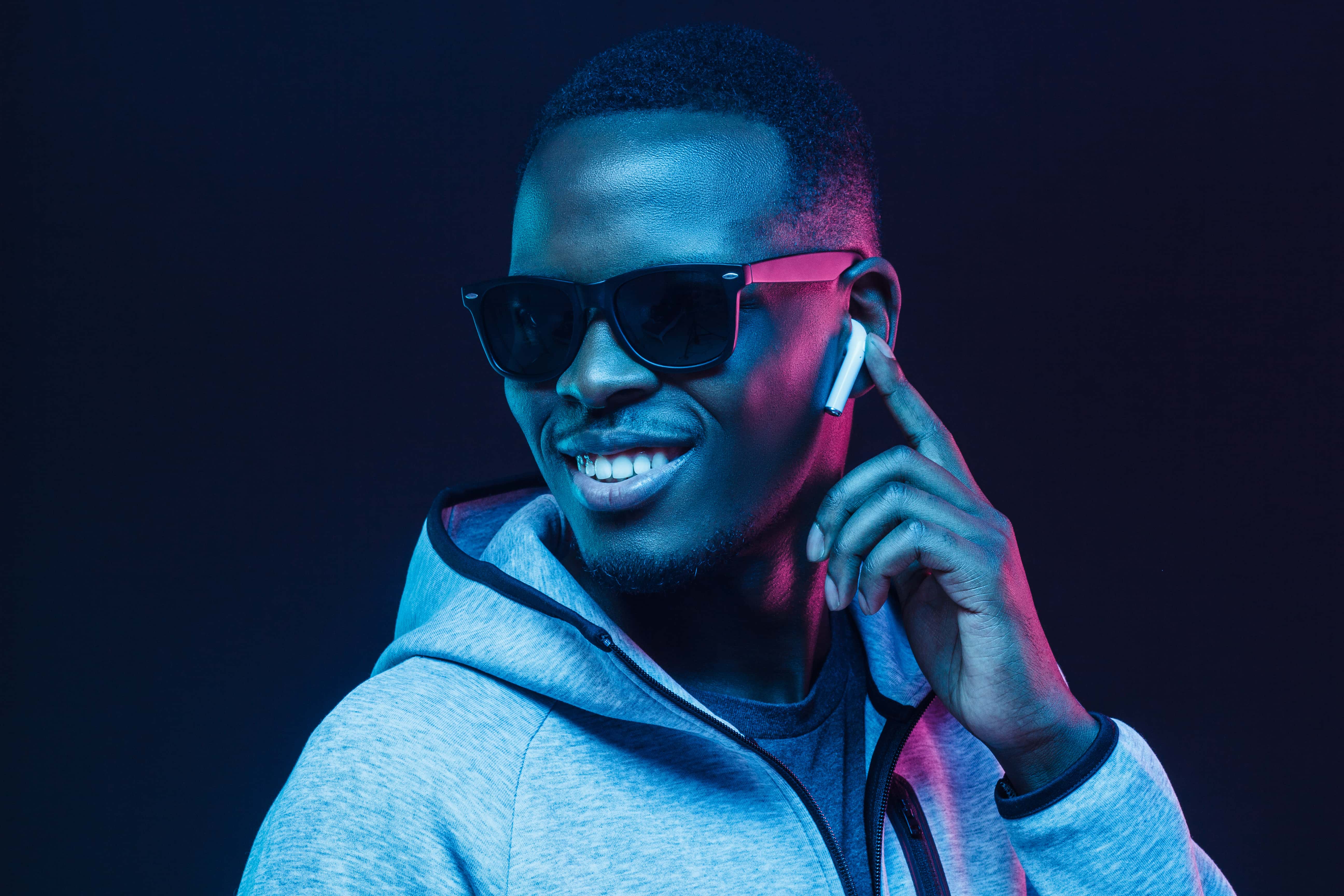 Young man with sunglasses listening to music