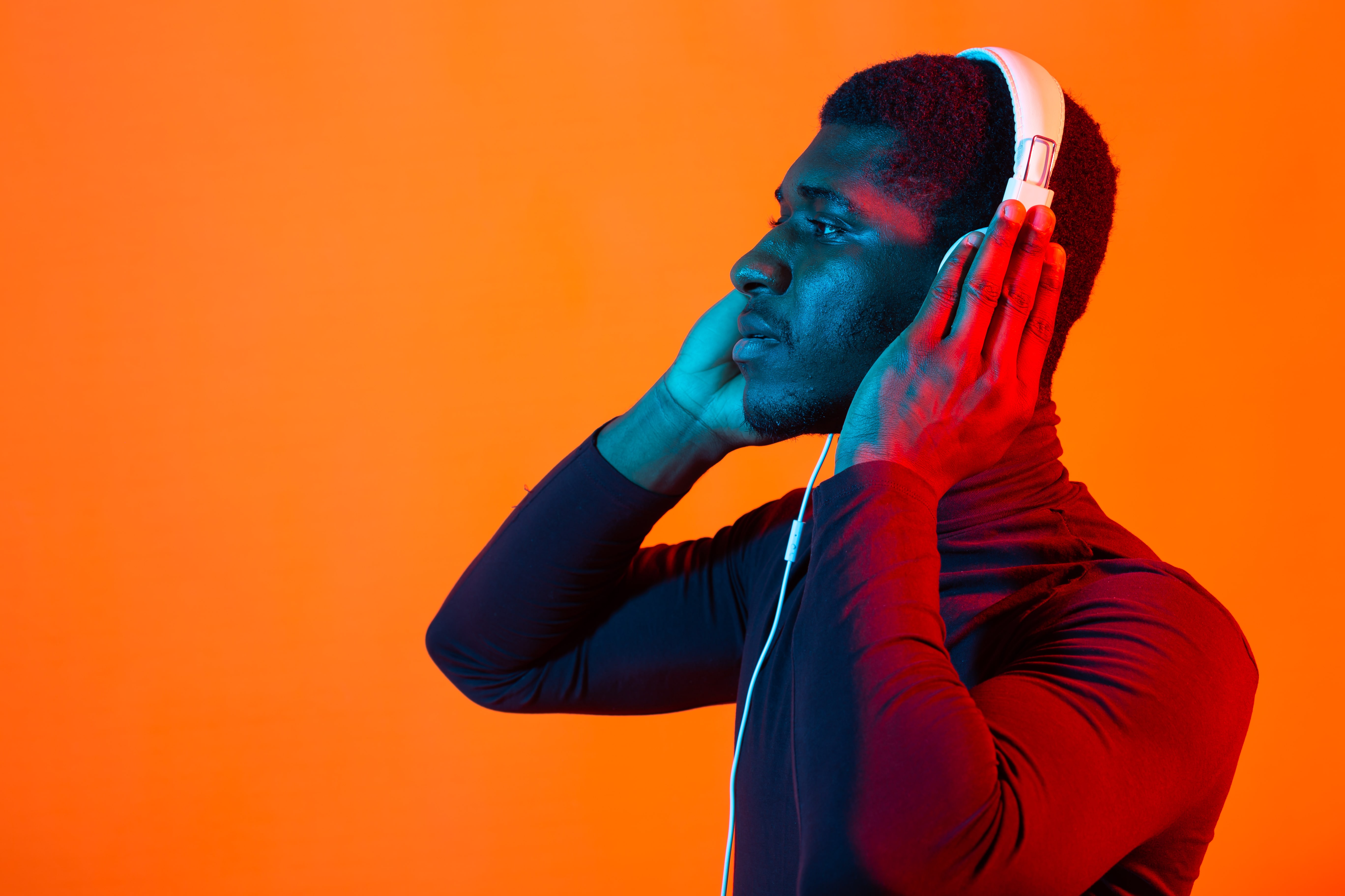 Young man in contemplative listening pose